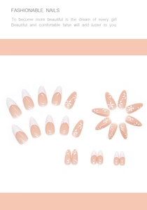Detail of almond-shaped press-on nails with white floral patterns and French tips