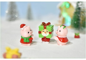 Detailed view of three festive pink resin pigs in Christmas hats for micro-landscape decor