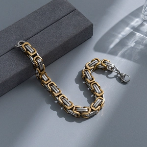 Detail of two-tone Byzantine emperor chain bracelet in gold and silver finish steel