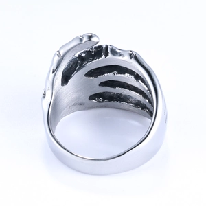 Gothic punk men's ring with silver skull hand skeleton claw design on white background