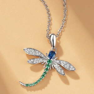 Elegant dragonfly pendant necklace with blue and green gemstones on silver chain