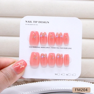 Handmade coral pink cat eye press-on nails with golden butterflies and purple flowers