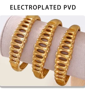 Detail of three gold fishbone bracelets featuring premium PVD electroplating finish