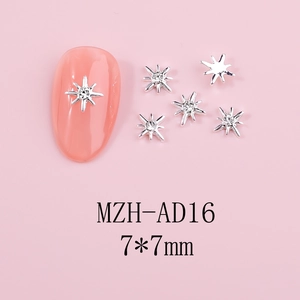 Macro shot of silver 7x7mm metal star nail charms with crystal rhinestone insets