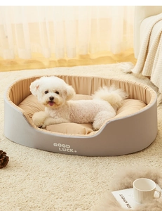 Detail of plush washable pet bed with 'GOOD LUCK' text in a cozy home setting
