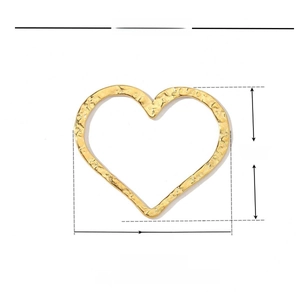 Macro detail of 30x26mm hammered gold heart pendant in durable stainless steel