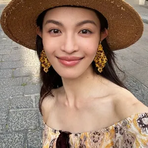 Close-up of a model wearing bohemian layered acrylic leopard print tassel earrings