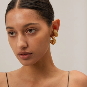 18k gold-plated stainless steel C-shape flower earrings with textured hammer finish on model