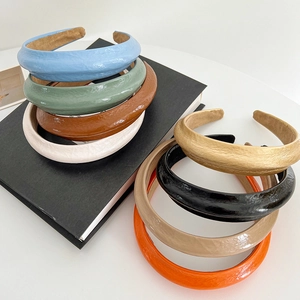 Detailed view of padded faux leather headbands in multiple vibrant colors and textures