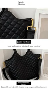 Detail of black quilted leather bag showing gold hardware and adjustable wide strap