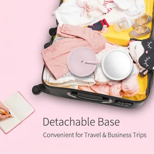 Portable LED makeup mirror with detachable base in pink, fits easily in a travel suitcase