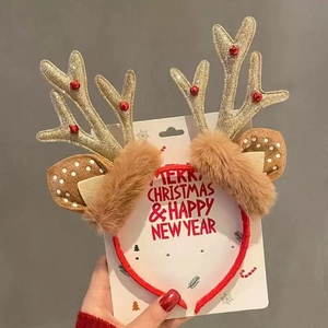 Detail of Christmas reindeer antler headband with gold sequins and brown plush ears