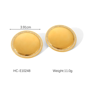 Macro view of 3.91cm gold geometric earrings with detailed white rhinestone borders