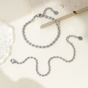 Detail of polished stainless steel oval bead bracelet featuring S.Steel engraved tag