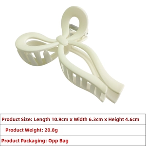 Detail view of large cream bow hair claw clip with dimensions 10.9x6.3x4.6cm and matte finish