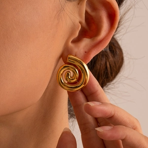 Minimalist 18K gold plated stainless steel spiral hoop earrings worn by a model