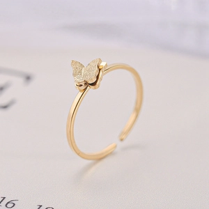 Close-up of matte butterfly gold ring with 18K plating and adjustable open band design