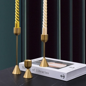 Elegant gold brass metal candle holder set on marble table for home decor