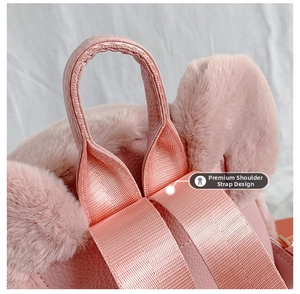 Detail of pink plush backpack showing the reinforced PU leather handle and nylon straps