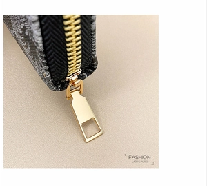 Detailed macro view of the premium gold zipper hardware on a luxury jacquard lady's purse