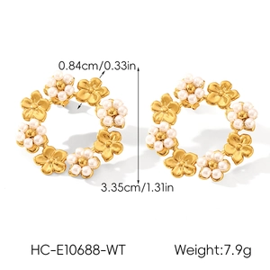 Detail showing dimensions of gold flower hoop earrings with white pearls and steel texture
