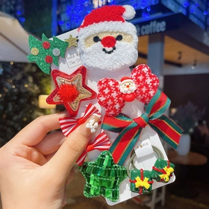 Detail van kersthaarclips set met Kerstman en glitterboom op een displaykaart