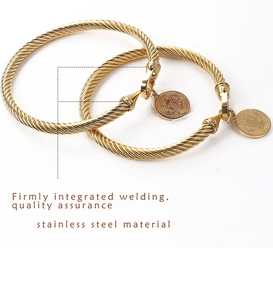 Detail of gold-plated stainless steel twisted rope bracelet with Saint Benedict medal