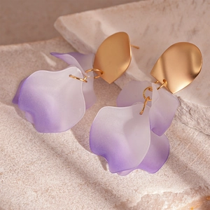Detail view of artistic resin petal earrings with purple gradient and matte gold finish