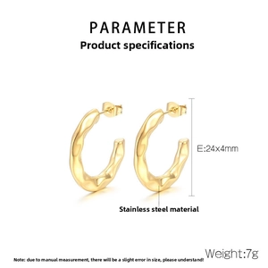 Detail view of gold stainless steel wavy hoop earrings measuring 24x4mm and 7g weight