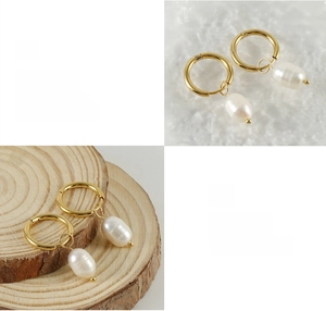 Detailed close-up of polished 18K gold stainless steel hoop earrings with baroque pearls