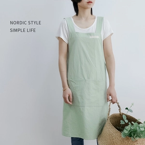 Minimalist light green cotton linen apron with wide straps and a large storage pocket