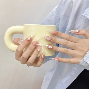 Detailed stiletto nails with 3d white flowers and pearls on light pink gradient