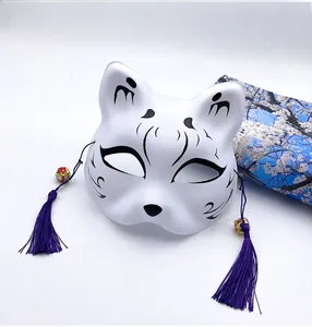 Detail view of Japanese kitsune mask with hand-painted patterns and purple silk tassels