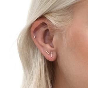 Minimalist gold S925 silver stud earrings set with sparkling zircon on female model