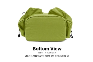 Detailed view of the reinforced rectangular base and drawstring adjusters on green backpack