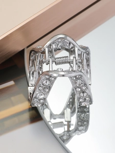 Detail of silver V-shaped hair claw clip with sparkling rhinestones and hollow design