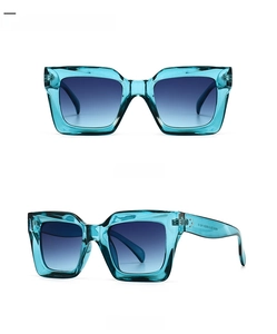Detail view of cyan blue square oversized sunglasses with gradient blue lenses and glossy frame