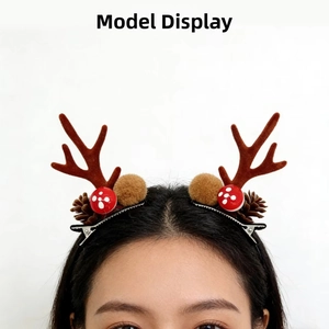 Close-up of Christmas reindeer antler hair clips with pine cones and plush mushrooms