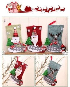 Detailed view of linen Christmas stockings with reindeer, Santa, and polar bear embroidery