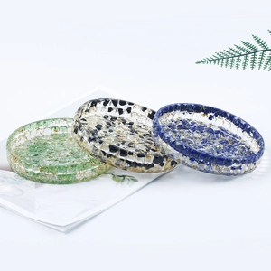 Three handmade resin crystal stone saucers with gold foil flakes in green, black, and blue