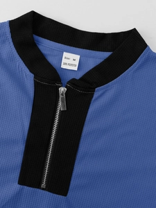 Macro detail of the blue waffle texture jacket featuring metal zipper and M size label