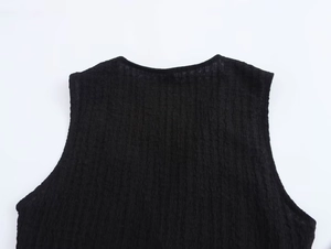 Detailed view of textured black sleeveless top featuring premium crinkle crepe fabric