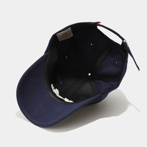 Detail view of cotton baseball cap interior featuring a 100% cotton wash label