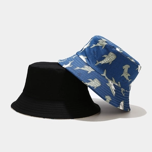 Reversible bucket hat with blue shark pattern and solid black cotton outdoor sun cap