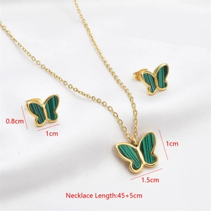 Macro detail of butterfly jewelry set showing dimensions of gold-plated green pendant and earrings