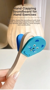 Close-up of a child holding a blue wooden cartoon animal castanet musical toy