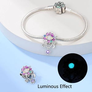 Detailed view of luminous floral charm bracelet with glow-in-the-dark beads and star pendants