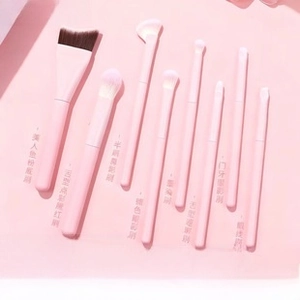 Detail view of 8-piece peach pink mini makeup brush set with soft ombré synthetic bristles