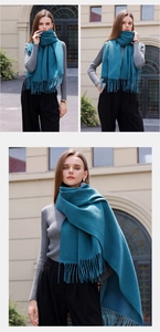 Detailed view of peacock blue winter scarf with soft fringes and cashmere-like texture