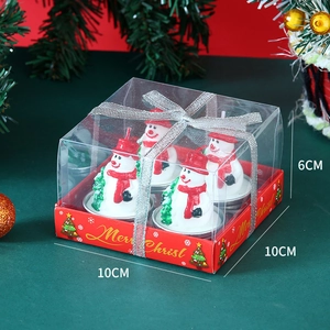 Close-up of four cute snowman candles in a clear 10x10x6cm PVC gift box with silver ribbon